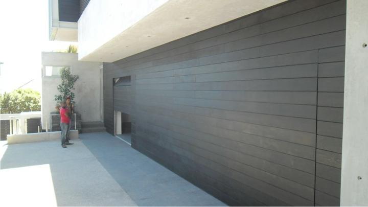 BH4 Doors 7.2m wide and 3m wide timber clad sectional overhead doors with flush centre mullion BH4 Doors 7.2m wide and 3m wide timber clad sectional overhead doors with flush centre mullion